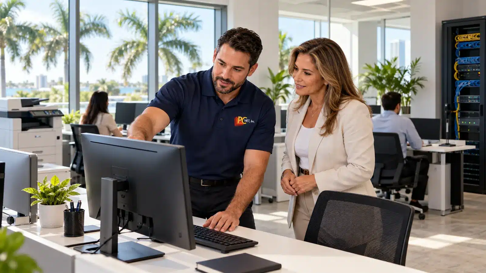 IT Support for Hialeah Businesses โ PC Net PC Net technician setting up computers and network equipment for a small business office in Hialeah